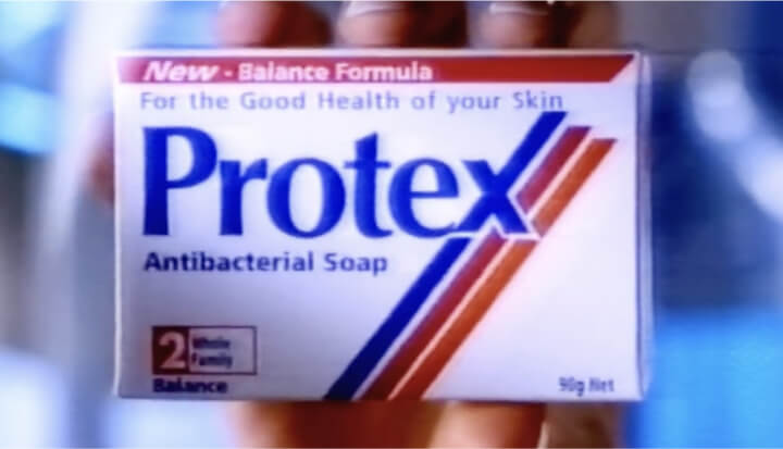 Protex antibacterial soap box from the 1980s with red, blue, and orange stripes, showing product name and label that reads "New - Balance Formula For the Good Health of your Skin".