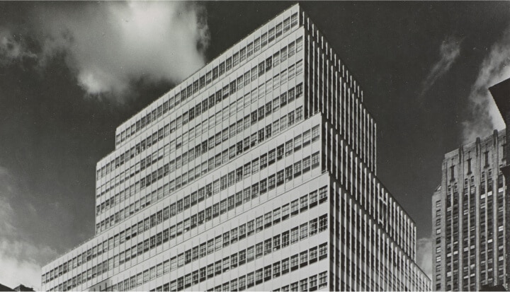 Black and white photo of the Colgate headquarters building from the 1950s